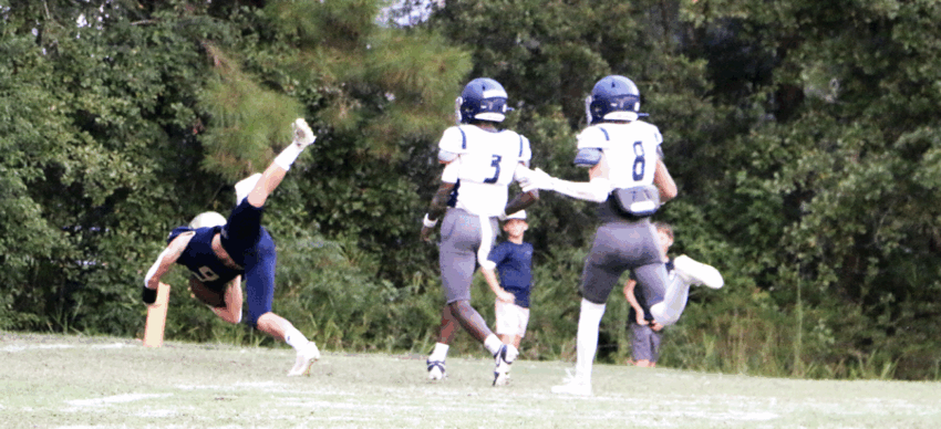 Will Borders (#6) dives for a touchdown in the early moments of the Warriors’ 20-14 win over the Blazers of Baconton Charter School. [Emerald Greene/Greene Publishing, Inc.]